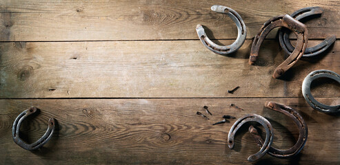 Old rusty horse shoes on barn floor