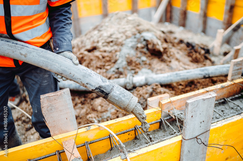 Construction site concrete pouring in castings on Reinforcing steel Bars at construction site. Men working. photo