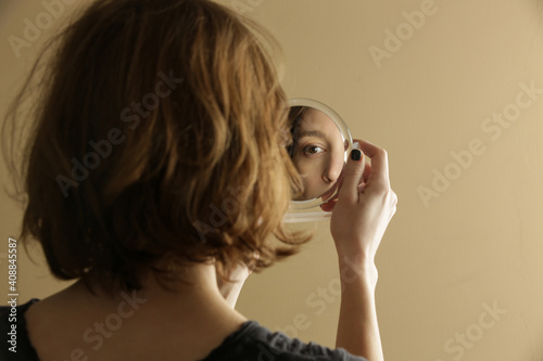 Canvas Print Mirror reflection of a woman's face, studio shot