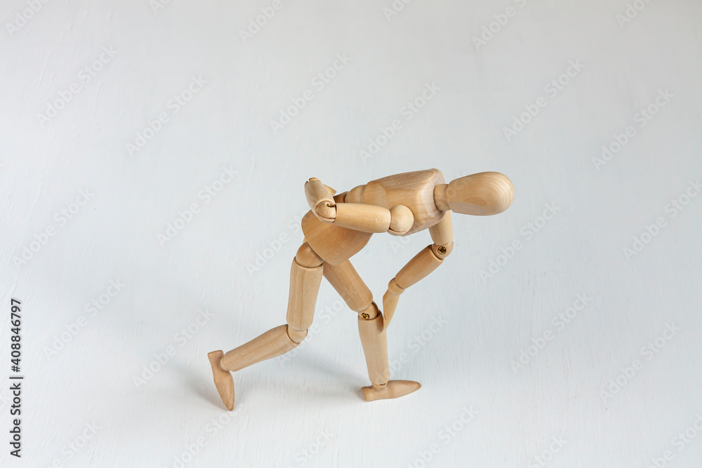 a bent wooden mannequin suffering from backache a bent wooden mannequin suffering from backache