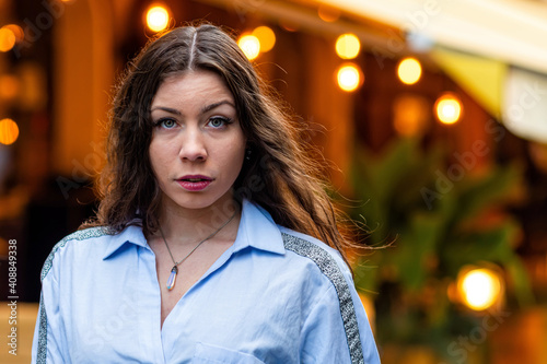 portrait of a cute and gorgeous women posing on blurred strret background with bokeh light