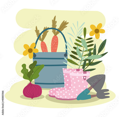 Gardening bucket with carrot boots shovel rake vegetables and flowers