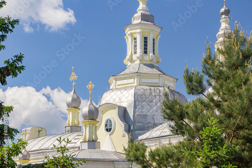 Domes and bell towers of the Orthodox Church in Minusinsk, bright blue sky. photo