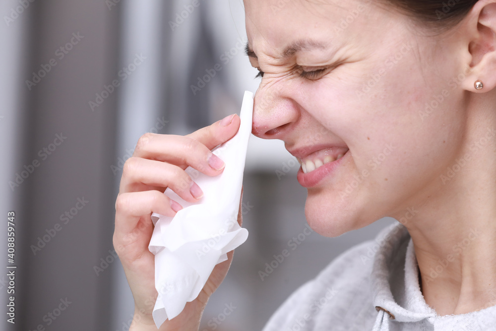 Herpes on the nose - Pretty young woman feels discomfort of herpes on her face and holds a handkerchief. Human Virus. Close Up of Nose with herpes simplex infection and blisters Herpes on the nose - Pretty young woman feels discomfort of herpes on her face and holds a handkerchief. Human Virus. Close Up of Nose with herpes simplex infection and blisters