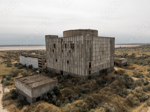 Main building view Giant construction in the middle of the field AERIAL SHOT CRIMEA near SHELKINO city AUGUST 2019 Old abandoned atomic power station from soviet union times photo