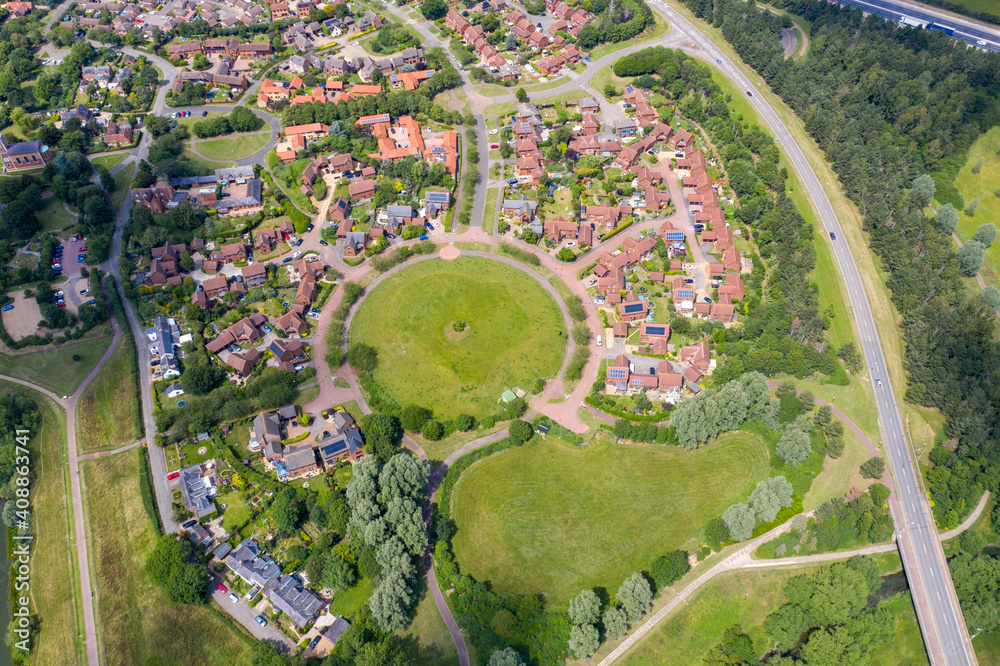 Aerial photo of the village of Milton Keynes in the UK showing a typical British housing estate on a sunny summers day taken with a drone from above