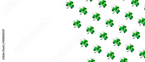 Banner with pattern Shamrock symbols made of green decorative glass hearts lying on white background and copy space. Happy St. Patrick's Day Irish holiday. Spring 17 march lucky clover design