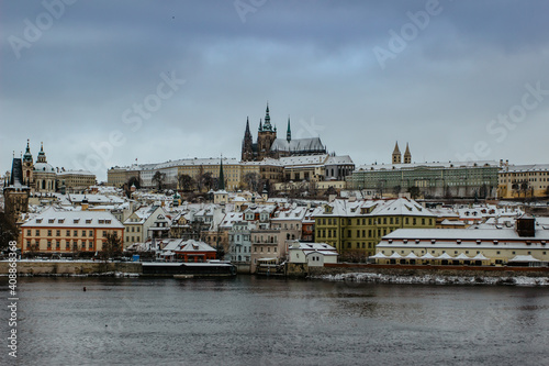 Scenic view of Prague Castle,Saint Vitus cathedral covered with snow and Vltava River.Wanderlust travel background copy space.Popular travel destination.Amazing Winter in Prague,Czech Republic.