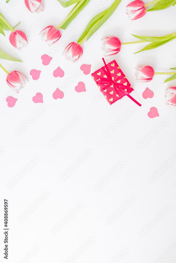 Flat lay valentines day frame with pink tulips and gift box on a white background Flat lay valentines day frame with pink tulips and gift box on a white background