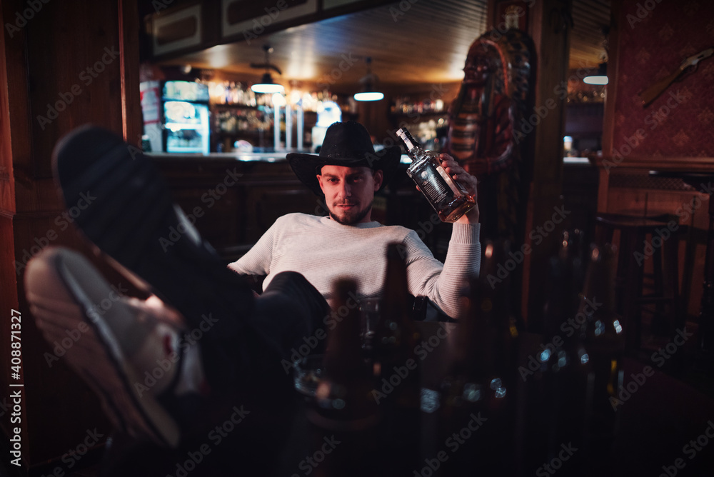 Cowboy smoking and drinking in a bar Cowboy smoking and drinking in a bar