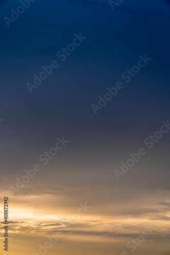 Calm dark sunset sky. Yellow and blue colours. Vertical photo © Dmitrii