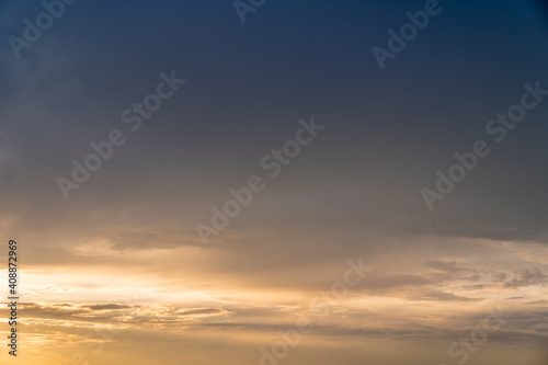 Calm dark sunset sky. Yellow and blue colours. Horizontal photo