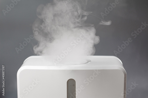 White air humidifier during work clean air and vaporizes steam up. Aromatherapy at home. Improving comfort of people. photo