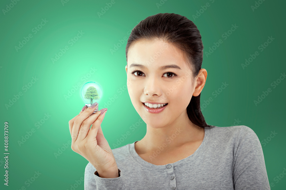 Oriental fashion young female holding a light bulb Oriental fashion young female holding a light bulb