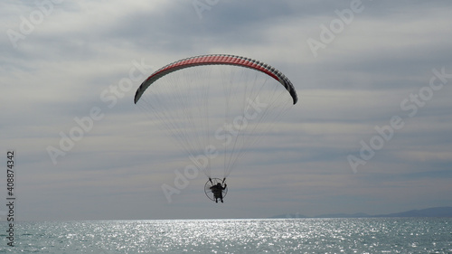Paraglider over Mediterranean calm sea