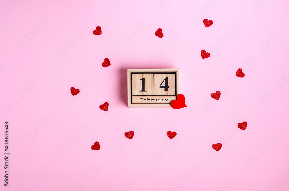 Wooden calendar with date February 14 and red heart on pink background. Wooden calendar with date February 14 and red heart on pink background.