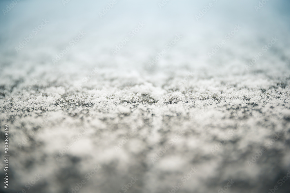 Close up of winter nature background of fluffy white snow. Abstract contrast of fresh snow melting on wet wooden deck plank surface. Soft focus Close up of winter nature background of fluffy white snow. Abstract contrast of fresh snow melting on wet wooden deck plank surface. Soft focus