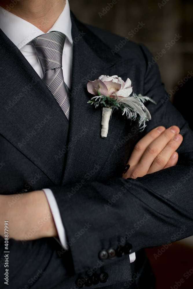 Male hands crossed on chest. Hands of the groom on the chest. boutonniere Male hands crossed on chest. Hands of the groom on the chest. boutonniere