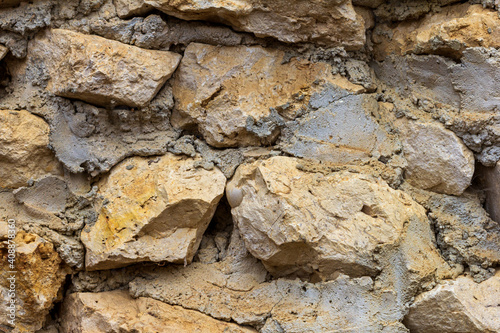 Elements of masonry of a stone wall made of natural stone, with the use of lime mortar.