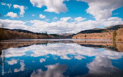 Fototapeta Naklejka Na Ścianę i Meble -  clouds mirroring on loch Faskally, Pitlochry. Picture taken from the dam