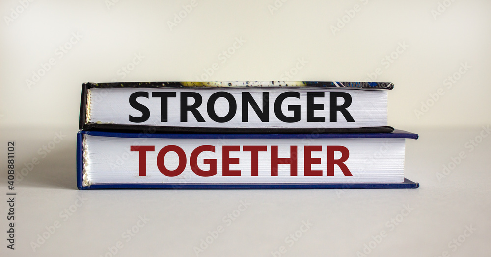 Stronger together symbol. Concept words 'stronger together' on books on a beautiful white background. Business, motivational and stronger together concept.