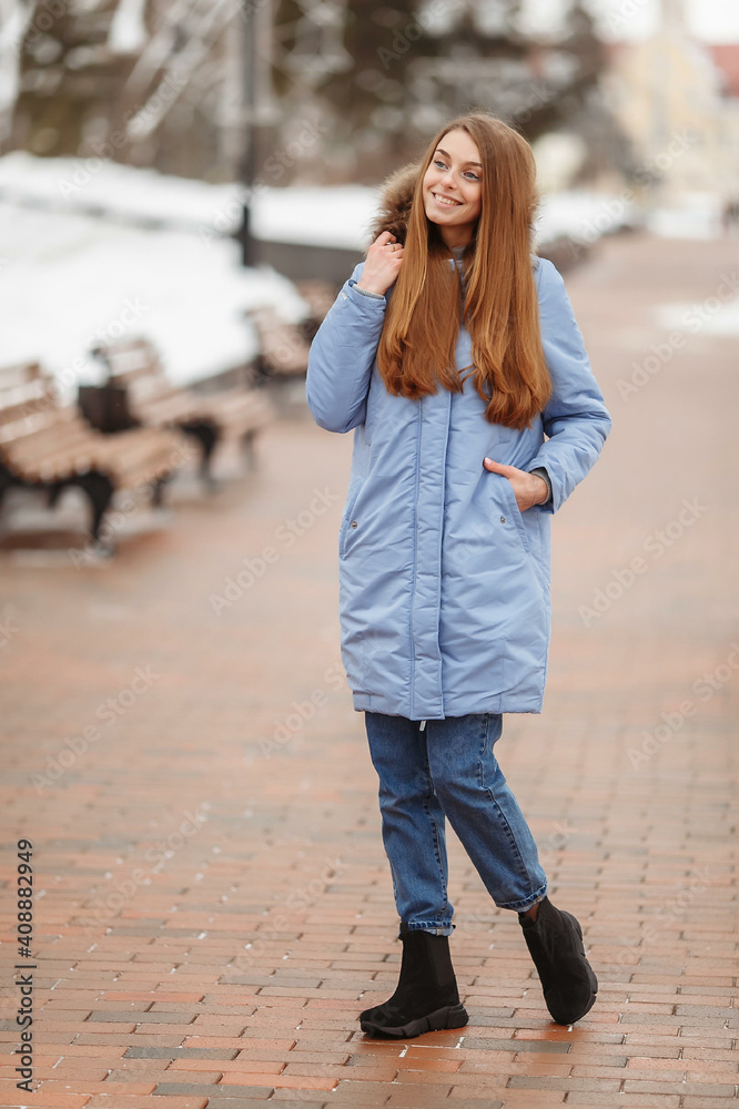 young woman are walking in the winter park. Winter park in the snow. Clothing advertising photo concept