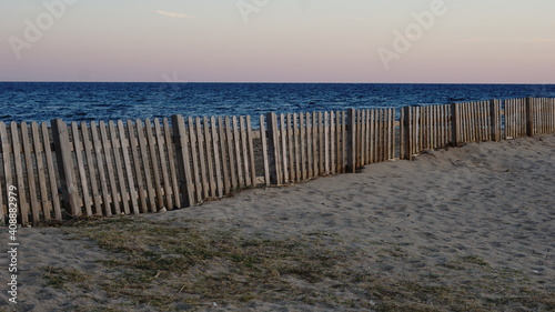 wooden fence on an empty beach
