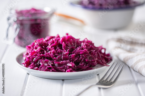 Red sauerkraut. Sour pickled cabbage on plate.