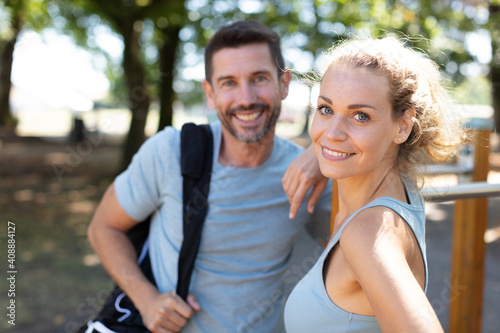joyful young couple going together to the gym