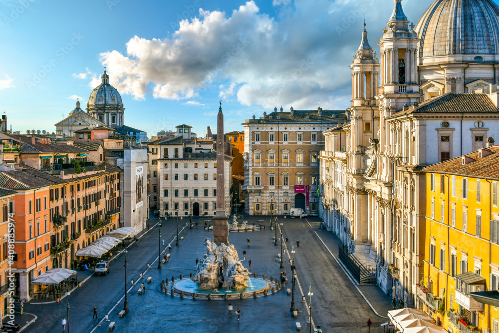View from a window overlooking the Piazza Navona early morning, showing the cathedral, sidewalk cafes, tourists and the fountain of the Four Rivers.