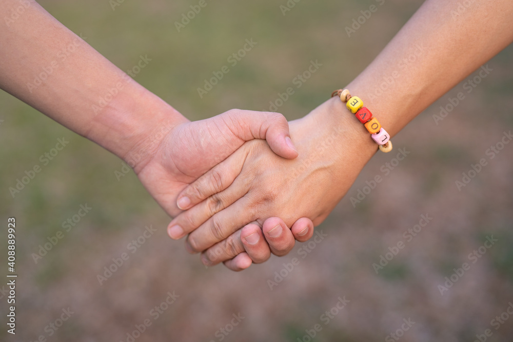 Couple holding hands with hand string of LOVE word in blur background, Happy Women's, Mother's, Valentine's Day concept. Couple holding hands with hand string of LOVE word in blur background, Happy Women's, Mother's, Valentine's Day concept.