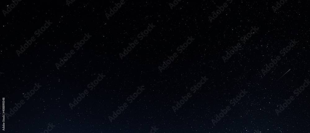 A starry sky with many stars and a flying meteor