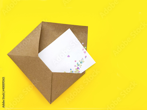 Craft hand made envelope on yellow background. Copy Space. Mock up.