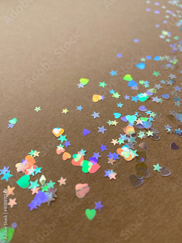 Glitters scattered on craft paper. Background