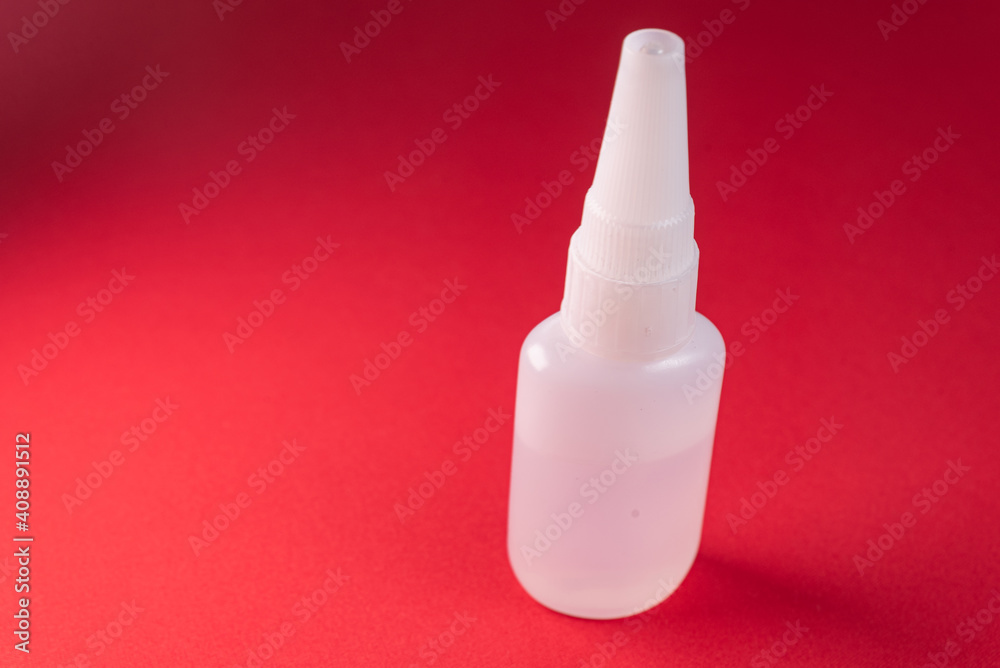 Glue bottle on the colorful background Glue bottle on the colorful background