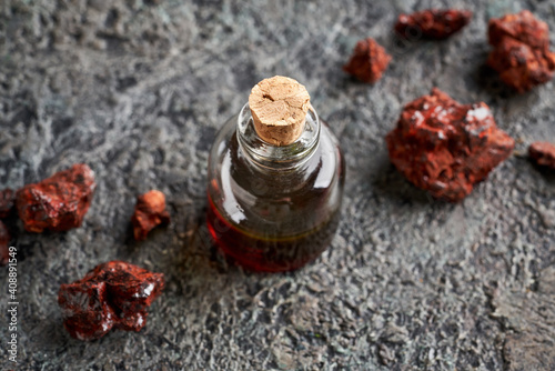 A transparent bottle of croton lechleri, or sangre de drago oil with Croton lechleri resin photo