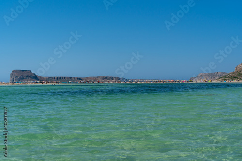 Panoramic view of Balos Lagoon near Chania, with magical turquoise waters, lagoons, tropical beaches of pure white, pink sand and Gramvousa island on Crete, Cap tigani in the center, low angle. Greece