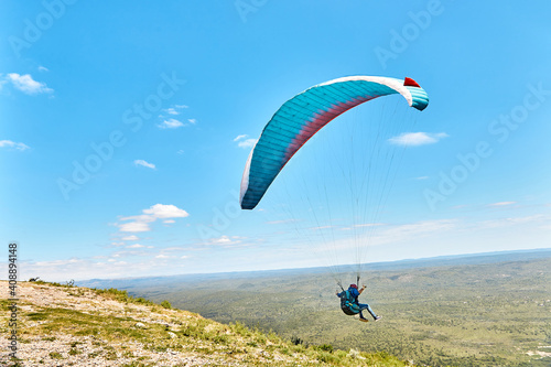 Paraglide fly over a mountain valley on a sunny summer day. Copy space. Cuchi Corral, Cordoba, Argentina, South America