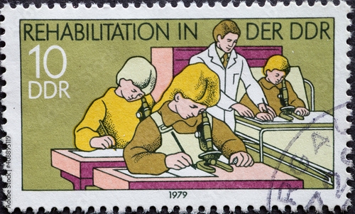 GERMANY, DDR - CIRCA 1979 : a postage stamp from Germany, GDR showing Rehabilitation of the disabled. Lessons in the hospital .