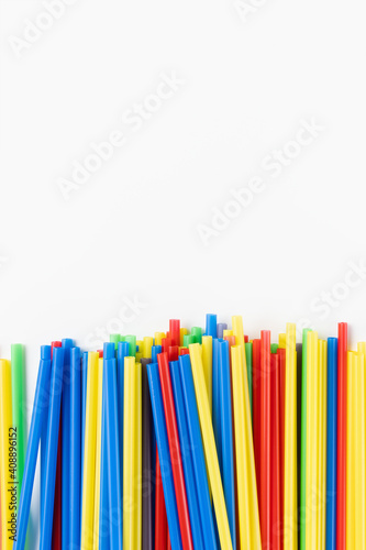 Many colorful plastic straws on white background. Recycle, environment conversation, pollution and plastic straw ban concept. Copy space
