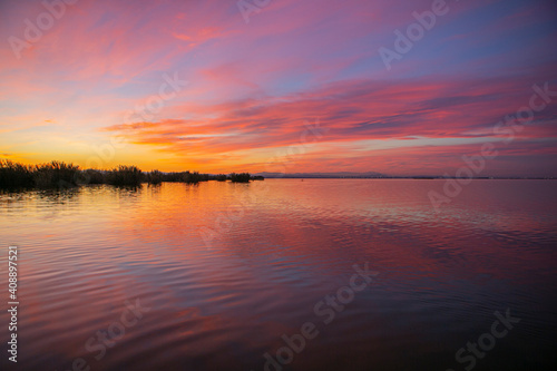sunset in the lagoon of valencia with very colorful clouds © Javier
