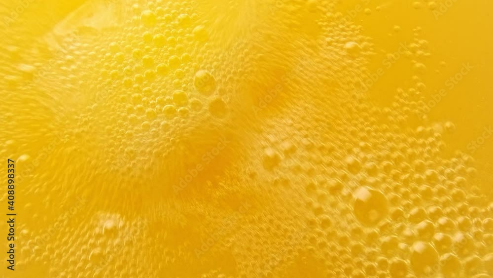 Yellow bubbling liquid boiling texture. Carbonated drink background. Yellow bubbling liquid boiling texture. Carbonated drink background.
