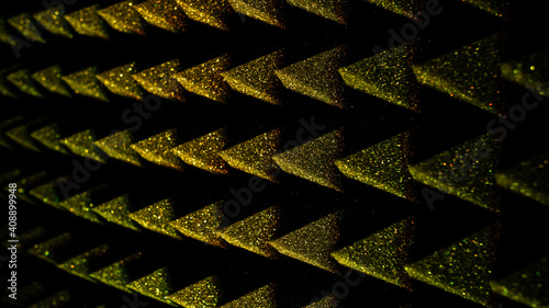 Background image of recording studio sound dampening acoustical foam.