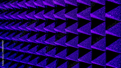 Background image of recording studio sound dampening acoustical foam.