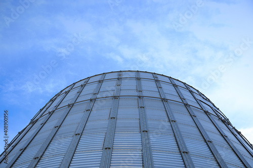 Modern granary for storing cereal grains against blue sky  low angle view