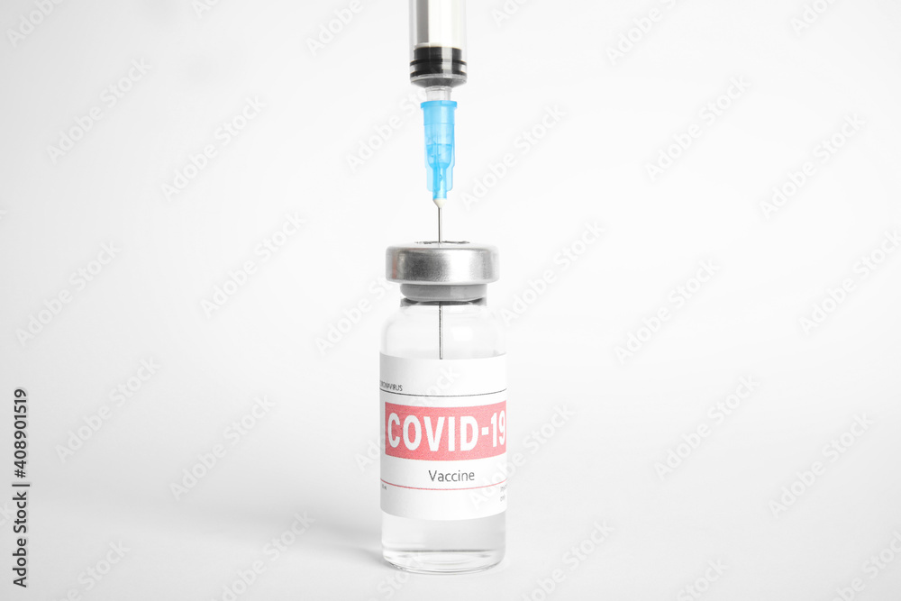 Filling syringe with coronavirus vaccine on white background