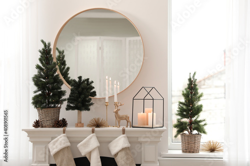 Fireplace in room with Christmas decorations. Interior design © New Africa