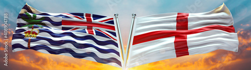 England Flag and Commissioner of the British Indian Ocean Territory flag waving with texture sky Cloud and sunset Double flag