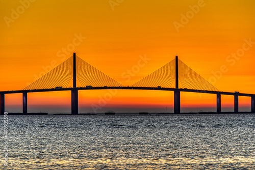 Sunrise behind bridge photo