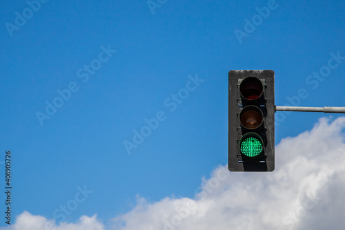 green traffic light on sky